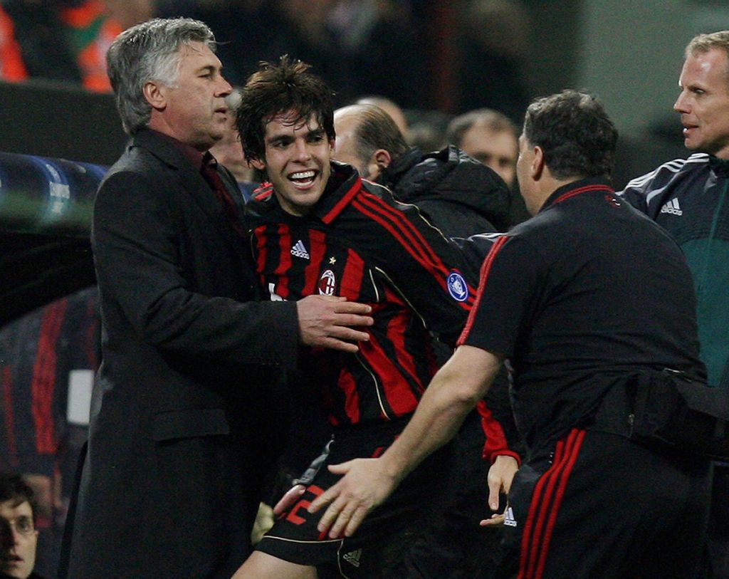 Milan, ITALY: AC Milan forward Kaka of Brazil (C) celebrates with his coach Carlo Ancelotti (L) after scoring against Celtic during the first period of extra time of their Champions League last 16 second leg football match at San Siro stadium in Milan, 07 March 2007. AFP PHOTO / Paco SERINELLI (Photo credit should read PACO SERINELLI/AFP via Getty Images)