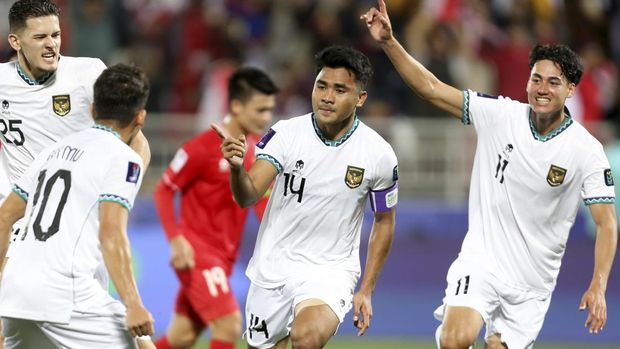 Indonesia's Asnawi Mangkualam Bahar, center, celebrates after scoring the opening goal from the penalty spot during the Asian Cup Group D soccer match between Vietnam and Indonesia at Abdullah Bin Khalifa Stadium in Doha, Qatar, Friday, Jan. 19, 2024. (AP Photo/Hussein Sayed)