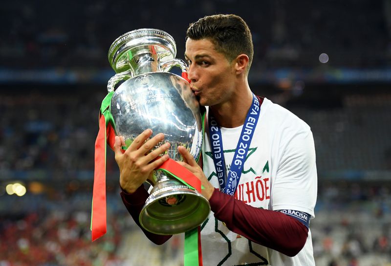 PARIS, FRANCE - JULY 10:  Cristiano Ronaldo of Portugal kisses the Henri Delaunay trophy to celebrate after their 1-0 win against France in the UEFA EURO 2016 Final match between Portugal and France at Stade de France on July 10, 2016 in Paris, France.  (Photo by Matthias Hangst/Getty Images)